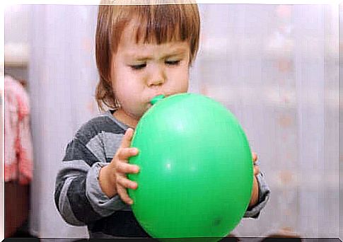 Boy inflates balloon