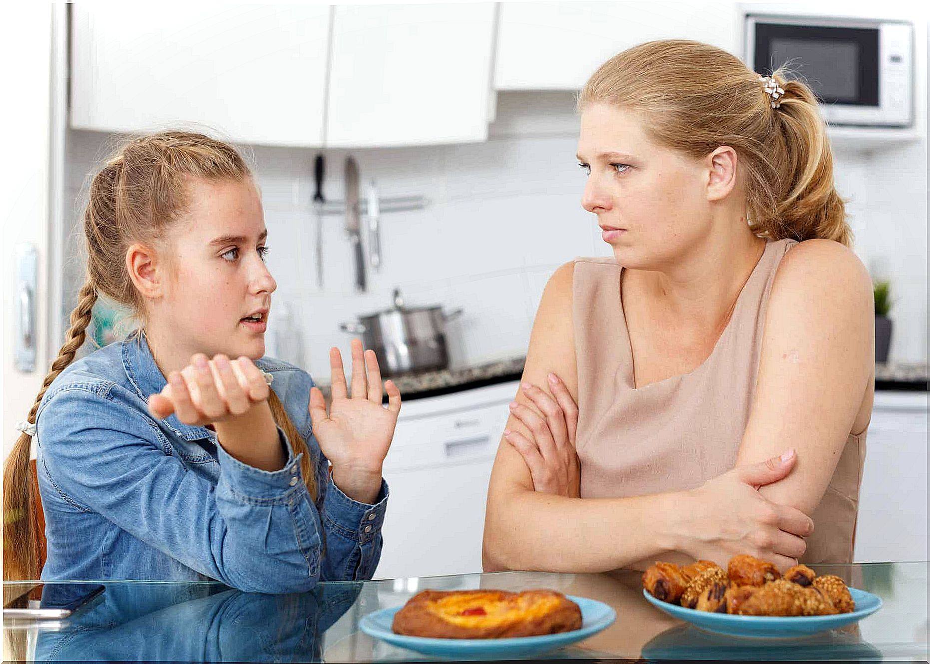 A teenage girl talking to her mother.