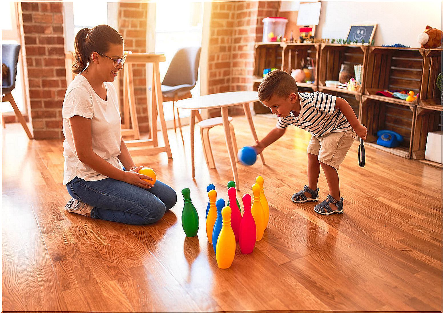 develop motor skills: children with plastic bowling pins
