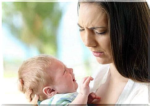 Anemia in infants: worried mother holding crying baby