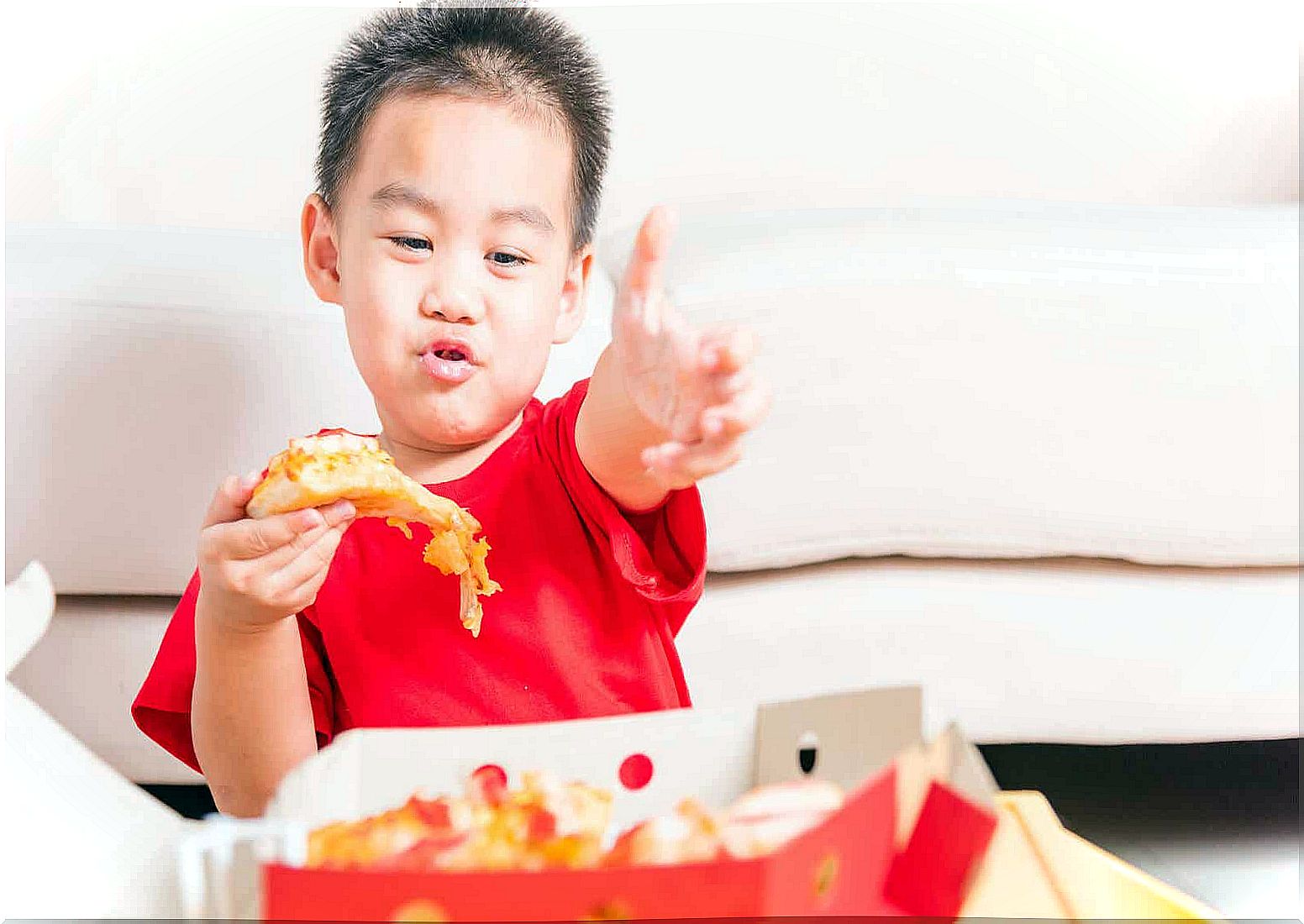 A child eating junk food.