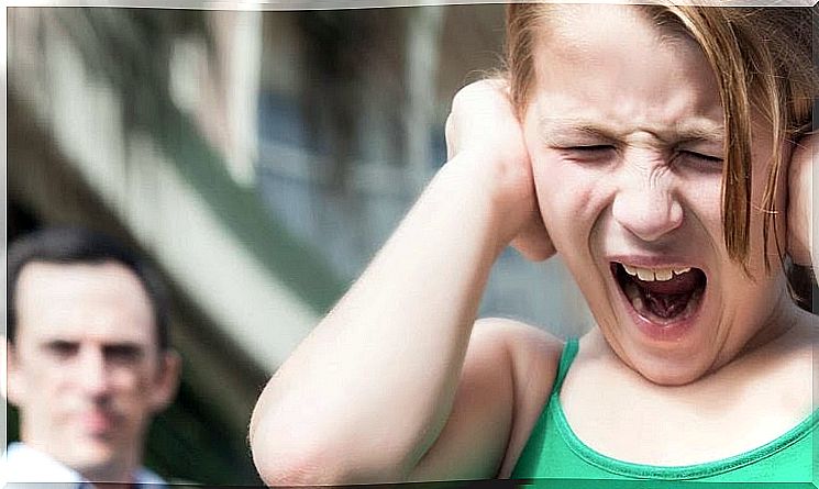 girl holding her ears and screaming