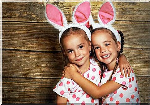 sisters with rabbit ears holding each other