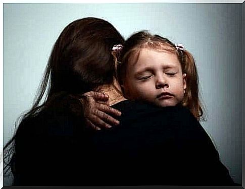 Emotional problems in children: A mother hugs her child.