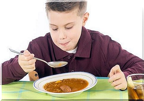 Boy eats soup