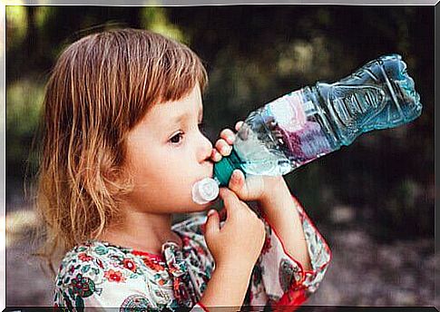 Children drinking water from water bottle.