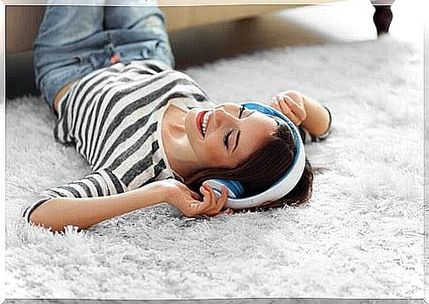 Teenager lying on the floor listening to music