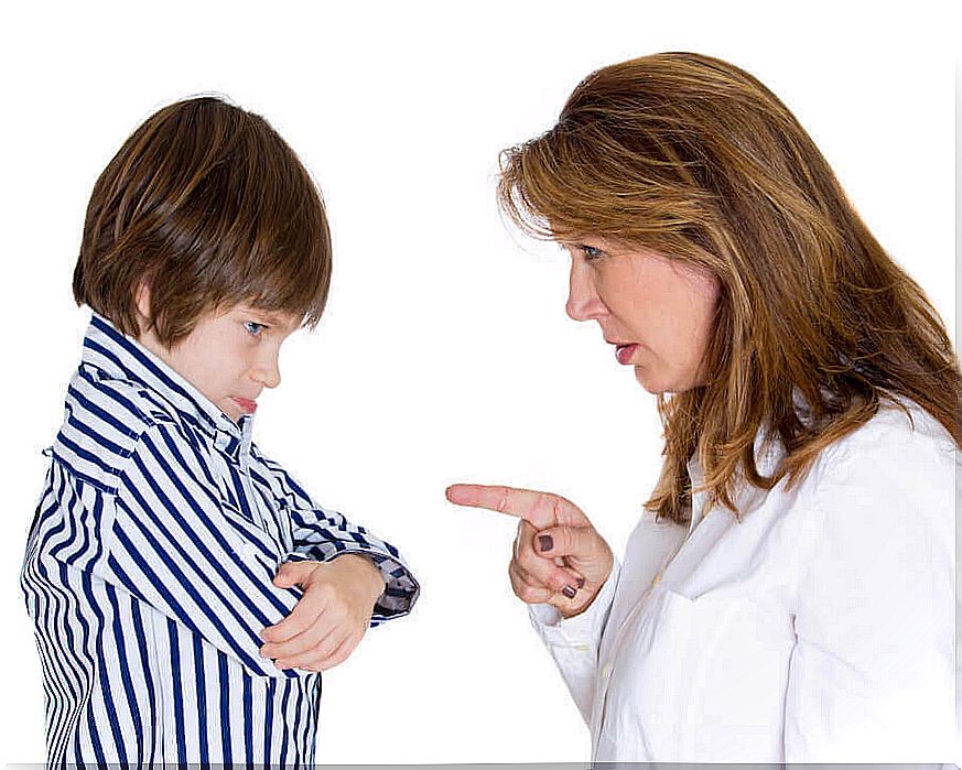 mother points finger at grumpy child