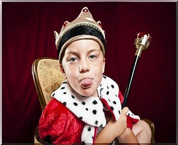 boy in royal clothes extends tongue