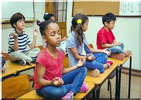 effective classroom: children meditate on their benches