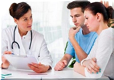 worried couple talking to doctor