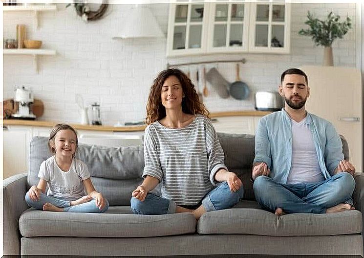Mindfulness and meditation: family meditating on sofa