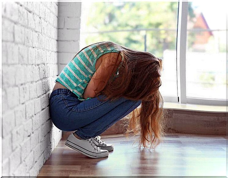 Get rid of bitterness: a teenage girl sitting crouched.