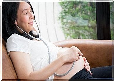 Woman listening to baby in the belly