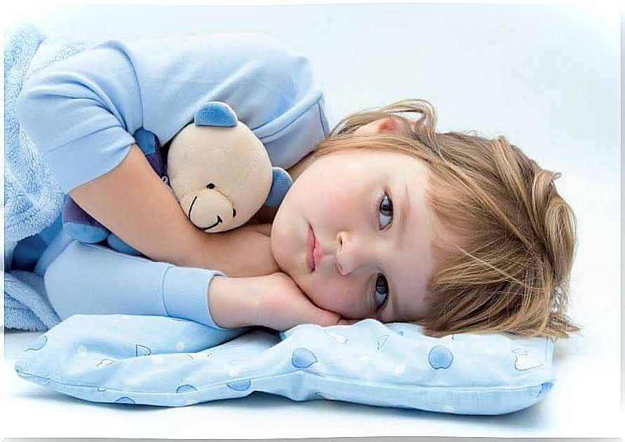 depressed child in bed with teddy bear