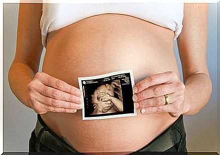 Woman holding up picture.