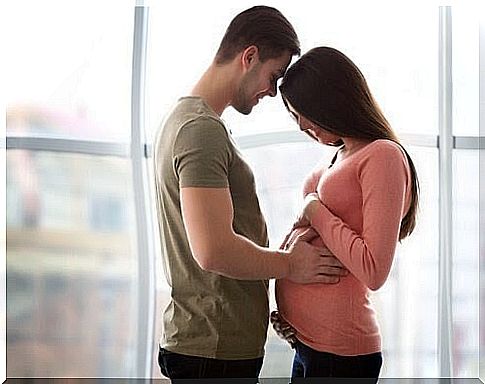 Man holding pregnant woman