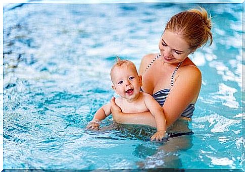 Baby swimming: mother and baby in pool