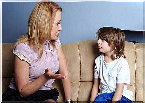 moral development: mother talking to son on sofa