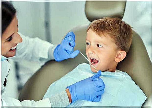 Dentist flosses children's teeth.
