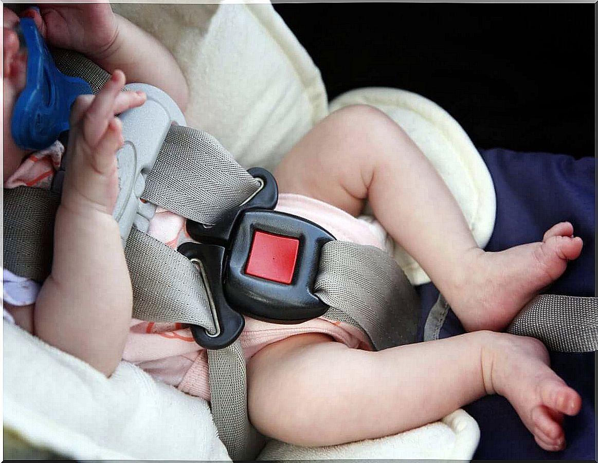 A newborn girl in a car seat.