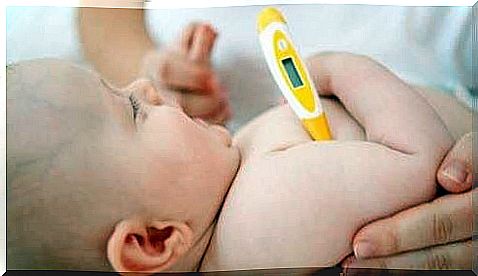 Baby with thermometer.